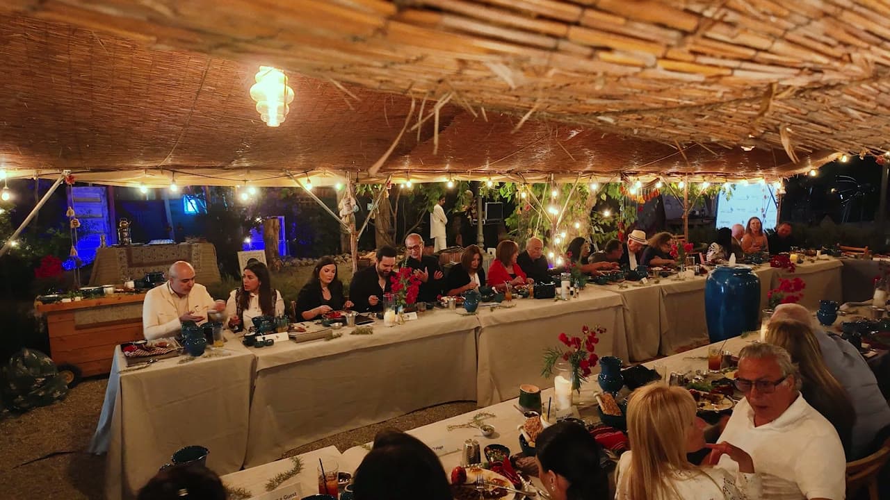 A Payani Media event: a long candlelit dinner table under string lights